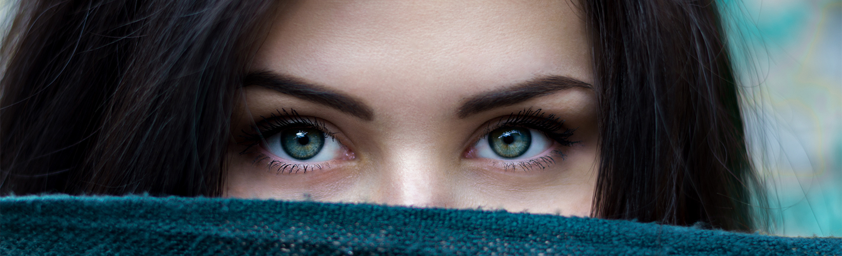 a woman who covers her eyes with a scarf