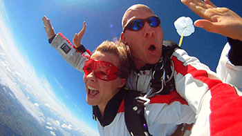man and woman skydiving during daytime