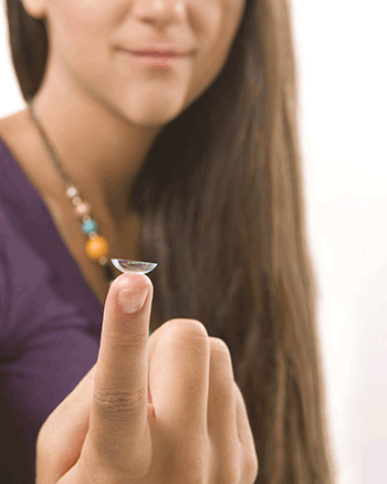 Close up of a girl holding a contact lens