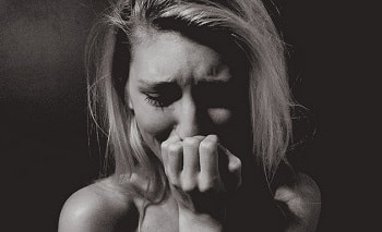 grayscale photo of a woman who is crying