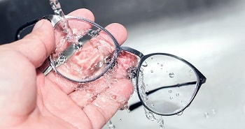 person washing hear glasses, accessories